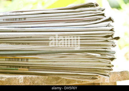 Pile of newspapers put on the wooden floor Stock Photo
