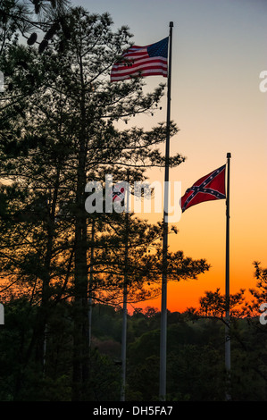 Flags flying at sunset near the base of the mountain hiking trail at Stone Mountain Park near Atlanta, Georgia. (USA) Stock Photo