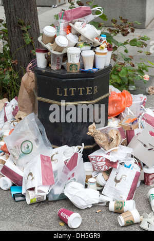 Takeaway bags and drinks containers overflowing from litter bin, London, England, UK Stock Photo