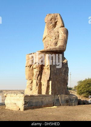 southern statue of the Colossi of Memnon, two huge ancient statues near Luxor in Egypt (Africa) at evening time Stock Photo