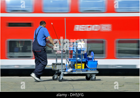 Cleaner with cart, central station in Stuttgart, Baden-Wuerttemberg Stock Photo