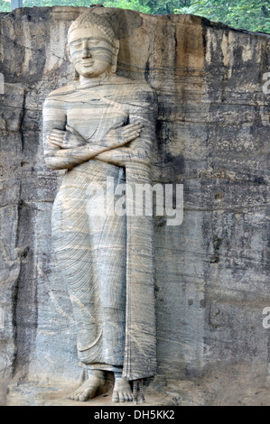 Standing statue with folded arms, historians and archaeologists suspect this to be the monk Ananda, a disciple of Buddha Stock Photo