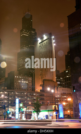 The Sears Tower, now names Willis Tower, in Chicago, looms over the city on a dark misty night Stock Photo