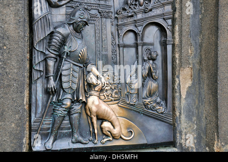 Bronze relief on the statue of St. John of Nepomuk, Nobleman with Dog, touching the dog brings good luck, Charles Bridge, Prague Stock Photo