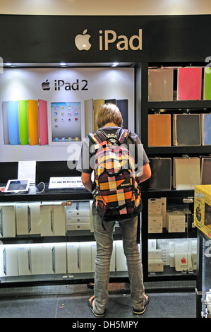 Eleven year old boy, iPad, Apple Store, Duty Free Shop, Suvarnabhumi Airport, Bangkok, Thailand, Asia, PublicGround Stock Photo