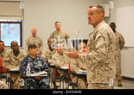 Brigadier Gen. Vincent A. Coglianese, commanding general, 1st Marine Logistics Group, speaks with Marines and sailors attending Stock Photo