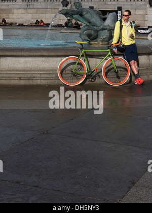 cyclist and bicycle resting in Trafalgar square London Stock Photo