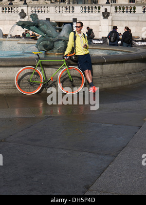 cyclist and bicycle resting in Trafalgar square London Stock Photo