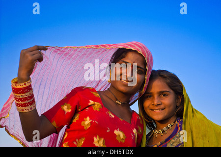 Two friendly Indian girls with colorful head scarves and jewellery, portrait, Pushkar, Rajasthan, India Stock Photo