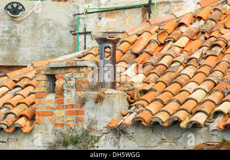 Rooftop tiles damaged with chimney in Dubrovnik Stock Photo