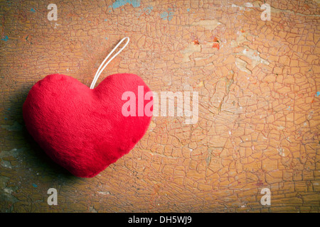 top view of red furry heart on old cracked background Stock Photo