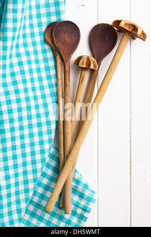 top view of wooden kitchenware with napkin on white wooden table Stock Photo