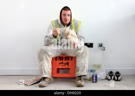 Brett Holland, Painter, having a meal break of chips and Irn Bru, while working at the refurbishment of Fairfield, Glasgow Stock Photo