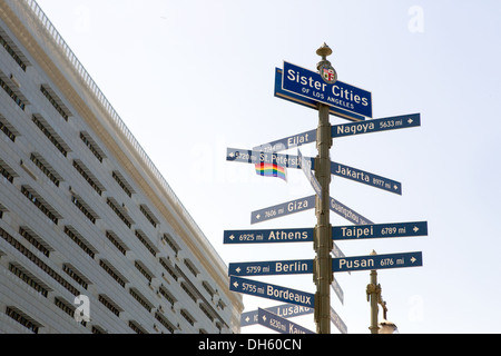 Street sign with the sister cities of Los Angeles and City Hall building Stock Photo