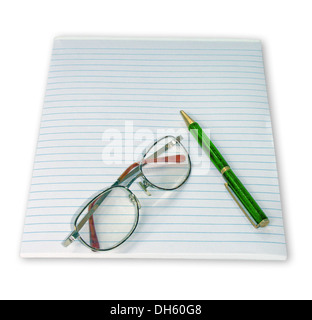 Ruled notepad with reading glasses and bright green ballpoint pen on plain white background Stock Photo
