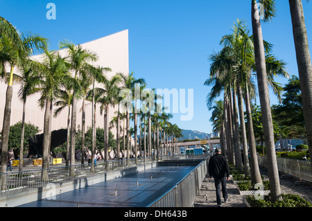 Walking along the Victoria Harbour waterfront in Hong Kong. Stock Photo