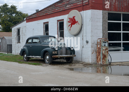 Classic Car parked alongside a vintage Mobil Gas station in rural Illinois along Route 66 Stock Photo