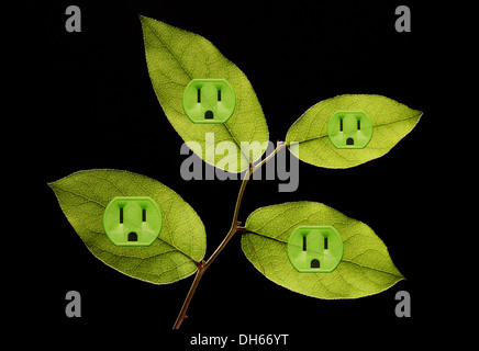 Four green plant leaves with green colored electrical outlets added. Black background Stock Photo