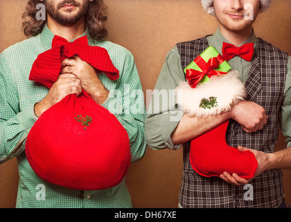Two guys at Christmas with gifts in hand Stock Photo