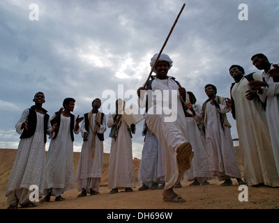 Bedouins dancing and singing, desert peoples from Egypt meeting in Wadi el Gamal National Park, Valley of the Camels, for the Stock Photo