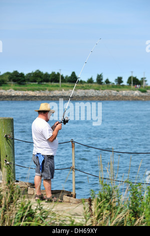 Fisherman fishing at the Cape Cod Canal, Sandwich, MA Stock Photo