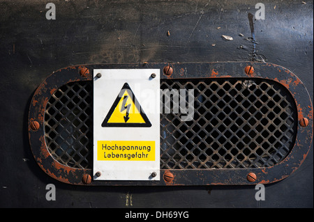 Sign 'Hochspannung Lebensgefahr' or 'Danger High Voltage', turbine house, old hydropower plant in Rheinfelden, 1898-2011 Stock Photo