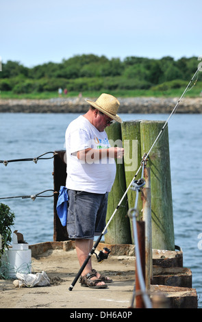 Fisherman fishing at the Cape Cod Canal, Sandwich, MA Stock Photo