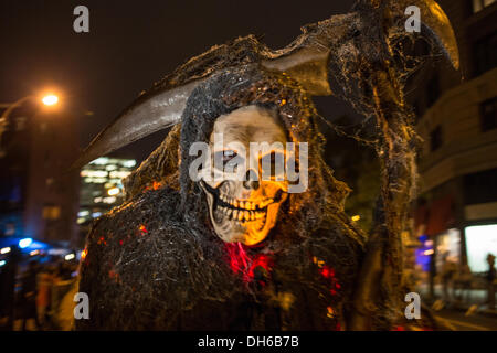 New York, NY, 31 October 2013. A very grim reaper wears cobwebs and caris a scythe in the Greenwich Village Halloween Parade. 2013 is the 40th anniversary of the parade, which was cancelled in 2012 because of hurricane Sandy. Credit:  Ed Lefkowicz/Alamy Live News Stock Photo