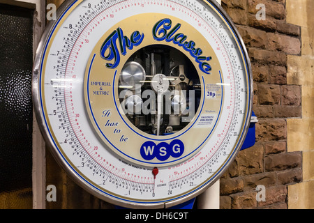 Old fashioned weighing scales on a railway station platform in Newport, Wales, GB, UK. Stock Photo