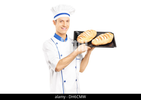 Smiling male baker holding freshly baked breads Stock Photo