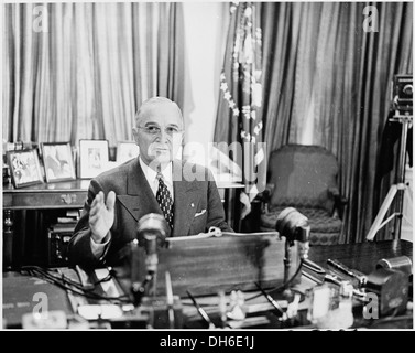 Photograph of President Truman at his desk in the Oval Office, posing for photographers on the occasion of his... 200356 Stock Photo