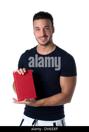 Smiling young man holding and showing book cover and looking in camera. Stock Photo