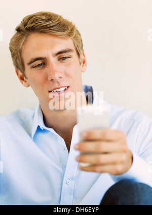 Young Professional, Handsome Man Using Smart Mobile Phone, Texting, Sending Text Message Stock Photo