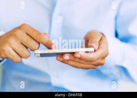 Young Professional, Handsome Man Using Smart Mobile Phone, Texting, Sending Text Message Stock Photo