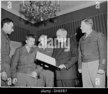 President Harry S. Truman (fourth from left) is presented with a bound volume of the German edition of the Stars and... 198696 Stock Photo