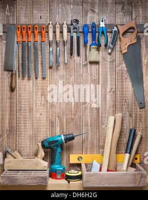 Carpentry tools hanging on the wall. Stock Photo