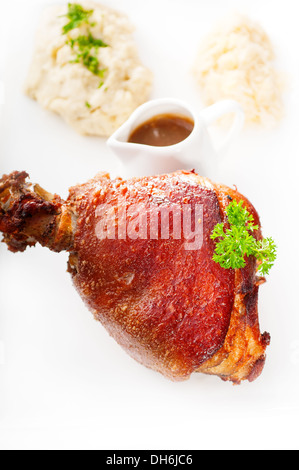 original German BBQ pork knuckle served with mashed potatoes and sauerkraut isolated on white ,MORE DELICIOUS FOOD ON PORTFOLIO Stock Photo