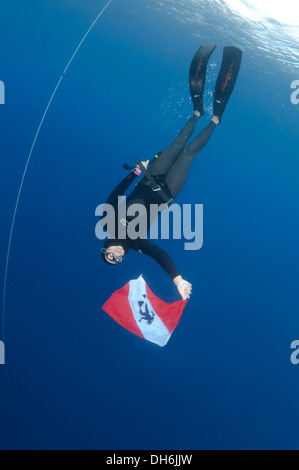 freedivers holds a diver down flag, Aegean Sea, island Symi, Greece Stock Photo