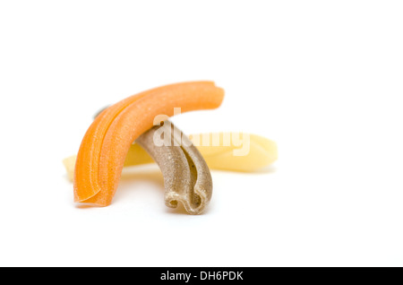Yellow, brown an orange Pasta Strozzapreti on white background Stock Photo
