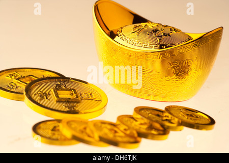 Gold ingots and copper coins Stock Photo