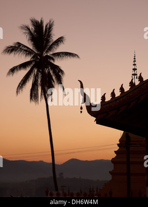 A silhouetted view of Wat Chomkao Manilat Buddhist Temple in Huay Xai, Laos. Stock Photo