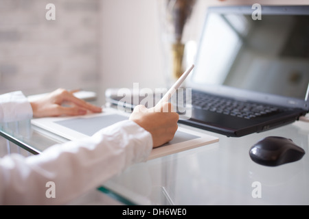 Female designer using graphics pad in office Stock Photo