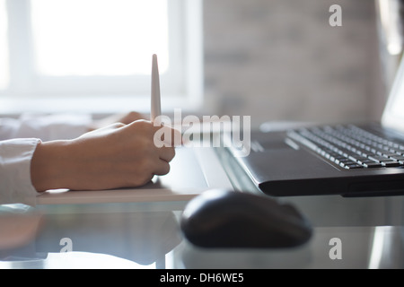Female designer using graphics pad in office Stock Photo