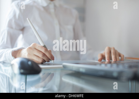 Female designer using graphics pad in office Stock Photo