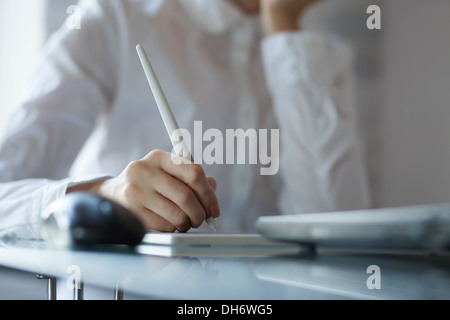 Female designer using graphics pad in office Stock Photo