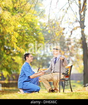 Man Helping Elderly Woman To Sit Up From Bed Stock Photo - Alamy