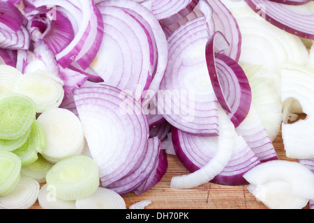 red, white onions and leeks on the chopping board. Stock Photo