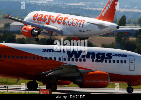 EasyJet plane landing and the aircraft Smartwings waiting for takeoff Airport Prague Stock Photo