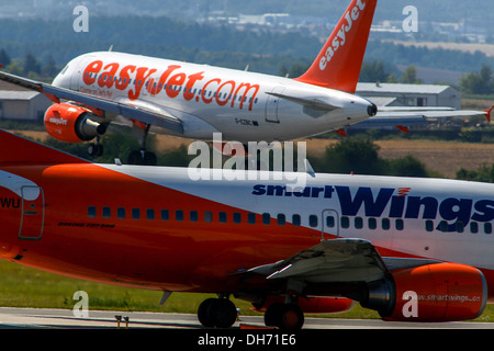 EasyJet plane landing and the aircraft Smartwings waiting for takeoff Airport Prague Stock Photo