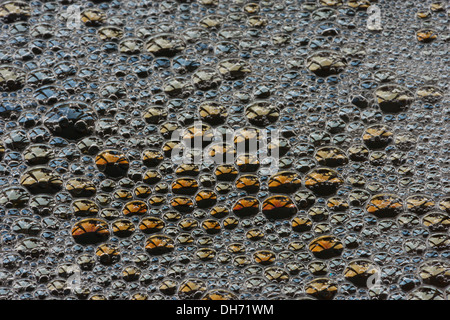 Bubbles with spectral colors being diffracted through thin surface film and refraction of light in water floating on top Stock Photo